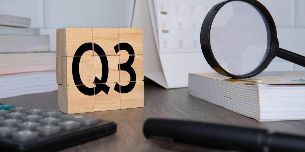 Close up image of wooden cubes with alphabet Q3 on office desk. Third quarter concept.